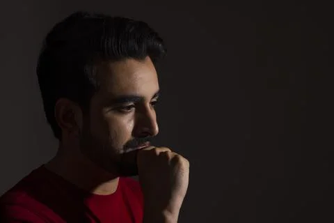 PORTRAIT OF A MAN POSING AND LOOKING DOWN Stock Photos