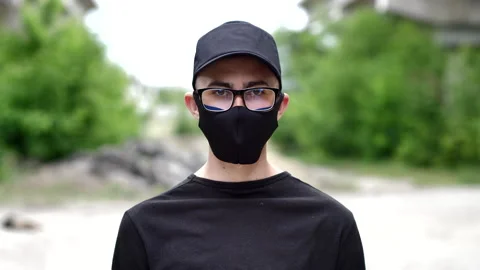 Portrait of a man in a protective mask looking at the camera. COVID-19 Stock Footage 131294235