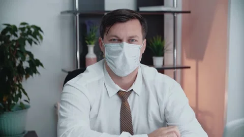 Portrait of a man putting on a protective disposable mask. Stock Footage 146264268