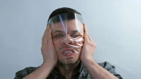 Portrait of man is puttion on plastic transparent film on his face. Stock Footage 167791525
