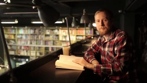 Portrait of a Man Reading a Book in a Bookstore, Library Stock Footage 73654341