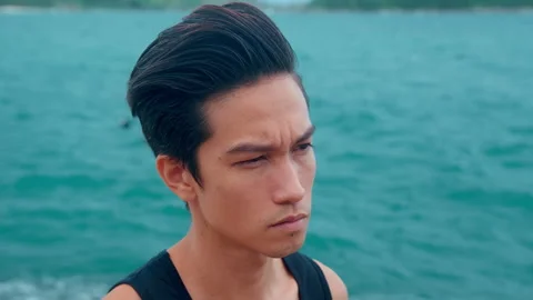 Portrait of a man is sad on the seaside Stock Footage 201212724