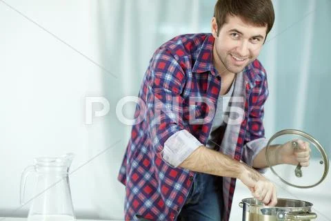 Portrait of man with saucepan looking at camera and smiling Stock Photos