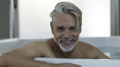 Portrait of man sitting in Jacuzzi Stock Footage 106320355