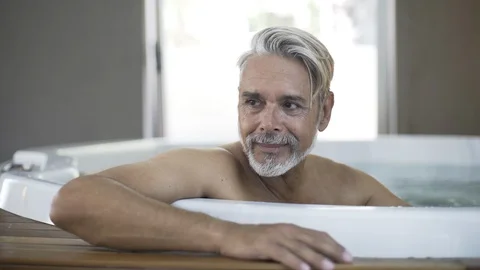 Portrait of man sitting in Jacuzzi Stock Footage 106320427