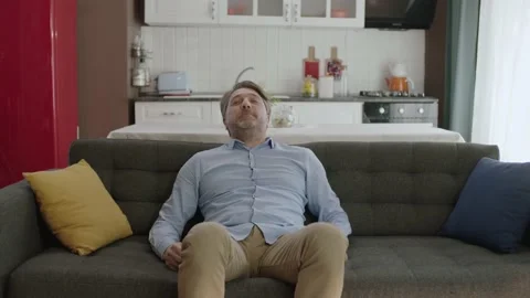 Portrait of man sitting on sofa at home. Stock Footage 185566778