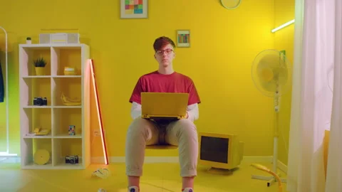 Portrait Of Man Sitting On Stool With Laptop Video stock 166344098