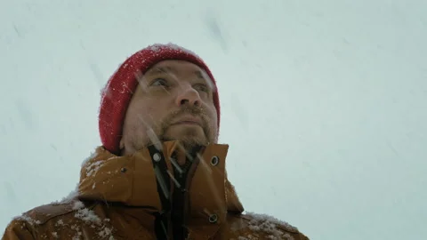 Portrait of a man in snowfall Stock Footage 166571707
