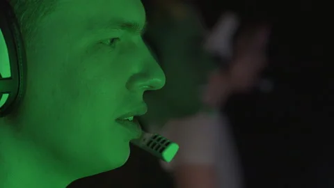 Portrait of a man speaking into a microphone playing a video game Stock Footage 151037653