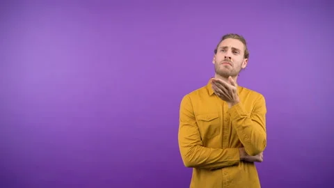 Portrait of a man spreading over a proposal on an isolated purple background Stock Footage 148837898