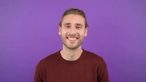 Portrait of a man spreading over a proposal on an isolated purple background Stock Footage 149326877