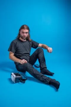 Portrait of a man stand down next to a VR device Stock Photos