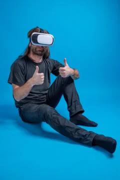 Portrait of a man standing down displaying thumbs up and enjoying a modern VR Stock Photos