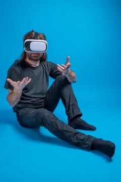 Portrait of a man standing down gesturing with his hands and enjoying a modern Stock Photos