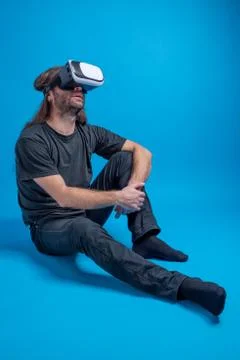 Portrait of a man standing down, looking up and enjoying a modern VR experience. Stock Photos