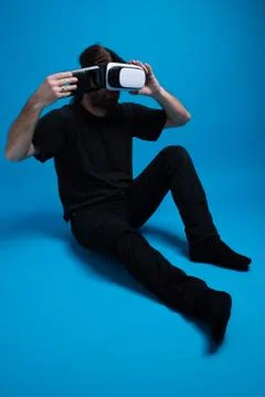 Portrait of a man standing down placing the phone box into the VR device Stock Photos