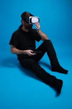Portrait of a man standing down preparing the phone box for the VR device while Stock Photos