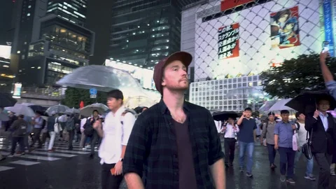 Portrait of Man Standing Still in Middle of Shibuya Crossing - Tokyo, Japan - Video stock 105058658
