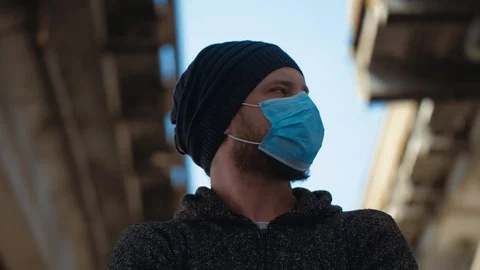 A Portrait Man Standing Under The Bridge In A Medical Mask.Corona Virus Pandemic Stock Footage 126686498