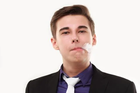 Portrait of a man in suit smoking an e-cigarette isolated on white Stock Photos