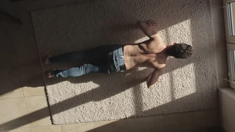Portrait of man with tablet doing push-ups workout exercise indoors at home. Top Stock Footage 229903906