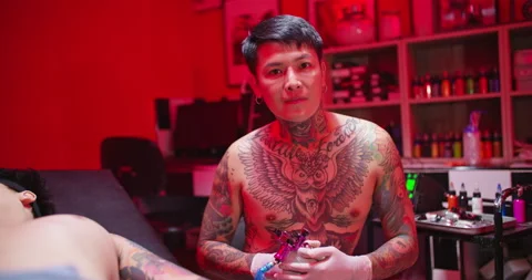 Portrait of man tattooist tattoo artist looking at camera in studio. Stock Footage