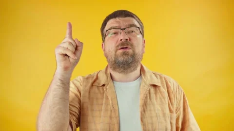 Portrait of man thinking pondering man having idea moment pointing finger Stock Footage 157818722