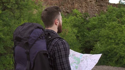 Portrait of a man tourist with backpack and map. Stock Footage