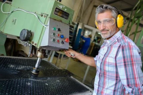 Portrait of man using industrial machine Stock Photos