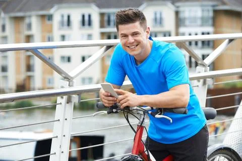 Portrait Of Man Using Mobile Phone Whilst Out On Cycle Ride Stock Photos