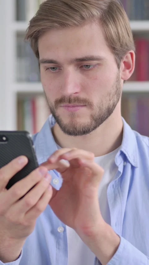 Portrait of Man using Smartphone, Vertical Video Stockbeeldmateriaal 339579695