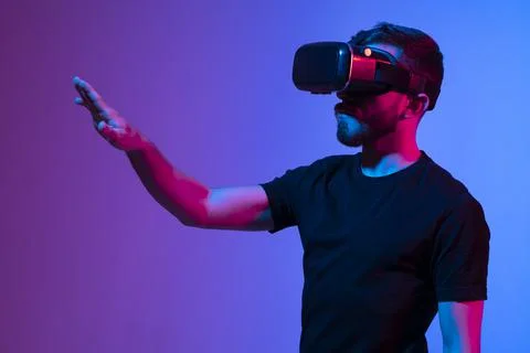 Portrait of man using VR headset while communicating with a friends in a Stock Photos