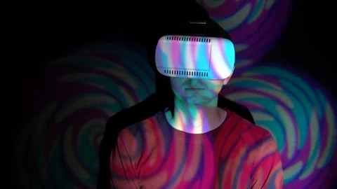 Portrait of man using VR-helmet in the spotlight Stock Footage 86608630
