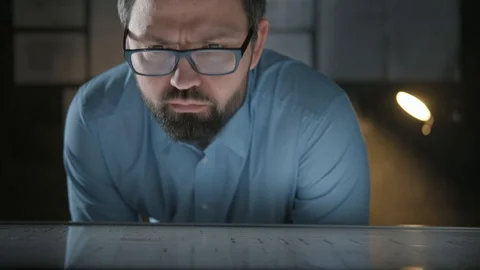 Portrait of man wearing glasses with interactive panel in dark room Video stock 121971965