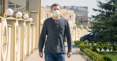 Portrait man wearing Protective Face Mask look at camera. Stock Footage 129049458
