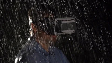 Portrait of man wearing virtual reality glasses. Using VR headset outside Stock Footage 80433750