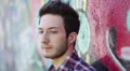 portrait of a man who is crying leaning against a colorful wall HD Footage