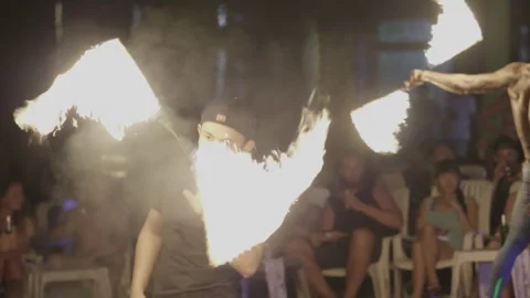 Portrait of man who performs the fire show on the beach at night Stock Footage 305106065