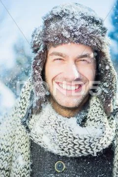 Portrait Of Man In Winter Clothes On A Beautiful Snowy Day