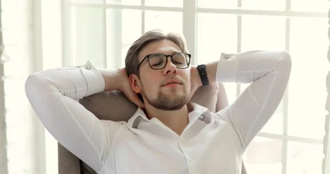 Portrait of man worker in glasses resting in his chair near window in ofiice. Stock Footage 131858424