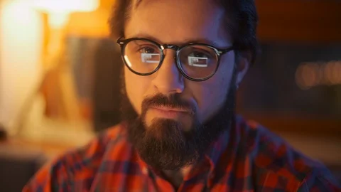Portrait Of a Man Is Working On Laptop Computer With Glasses At Night Close Up Stock Footage 128019602