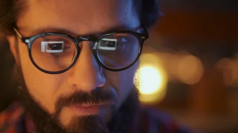 Portrait Of a Man Is Working On Laptop Computer With Glasses At Night. Close Up Stock Footage 128019725