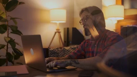 Portrait Of a Man Is Working On Laptop Computer With Glasses At Night Stock Footage 128019753