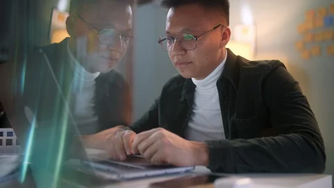 Portrait Of a Man Is Working On Laptop Computer With Glasses At Night Stock Footage 128019881