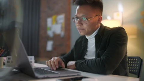 Portrait Of a Man Is Working On Laptop Computer With Glasses At Night Stock Footage 128020031