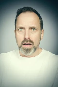 Portrait of man's face in studio when trying expressions Stock Photos