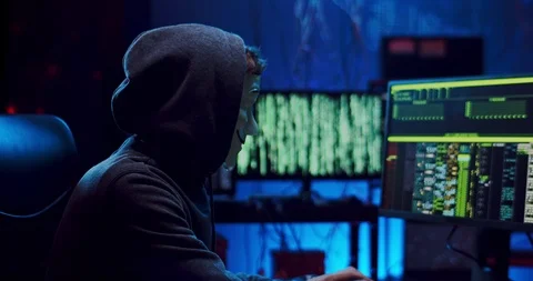 Portrait of the masked anonymous man breaking servers and hacking data at the Video stock 124349907