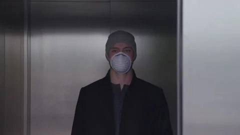 Portrait of a Masked Man in a Beanie Inside an Elevator Stockbeeldmateriaal 208776723