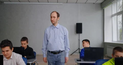 Portrait Of Math Teacher Walking In Computer-Based Classroom In Middle School Stock Footage 280175056