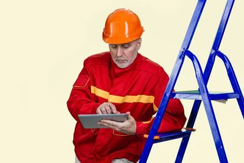 Portrait of mature contruction worker is using a tablet pc device. 스톡 사진